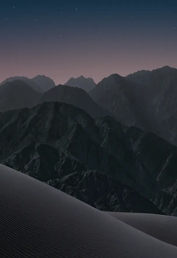 Dark sand dunes and mountain ridges beneath a starry blue night sky. iPhone Duo Night (Dark) wallpaper preview.